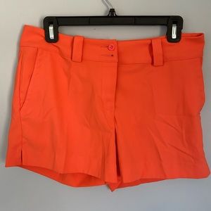 Nike orange golf shorts for women, size 6.